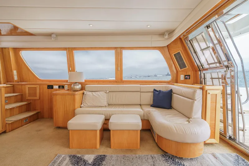 Sweet Seas Yacht Photos Pics Luxurious interior of 2001 McKinna 57 Pilothouse yacht with beige seating and ocean view.