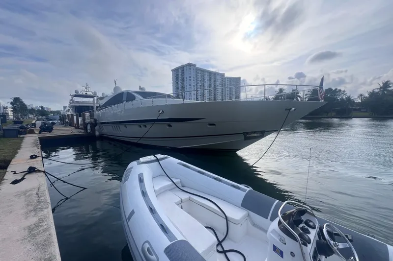  Yacht Photos Pics Luxury Leopard 27m yacht docked at marina, 2005 model, with inflatable boat in foreground.