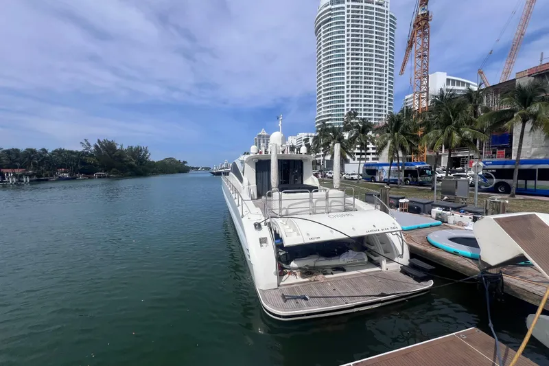  Yacht Photos Pics Luxury Leopard 27m yacht docked by waterfront skyscraper, 2005 model.