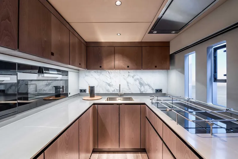  Yacht Photos Pics Luxurious kitchen interior of 2026 Sunreef 60 Sunreef Power yacht with modern wood cabinetry.