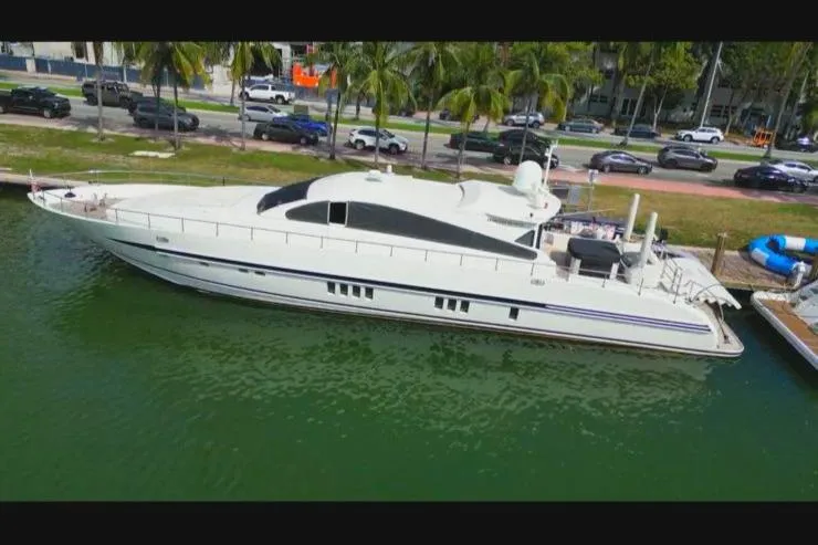  Yacht Photos Pics Luxury Leopard 27m yacht from 2005 docked by a scenic waterfront.