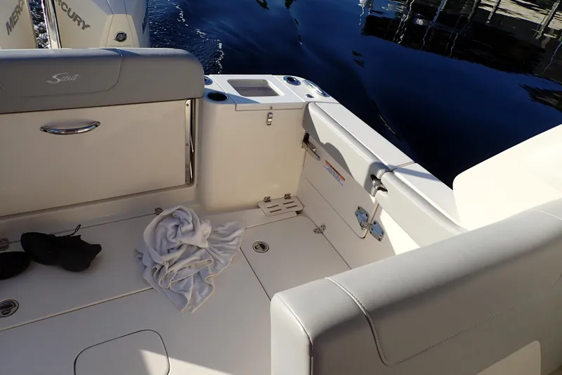  Yacht Photos Pics 2021 Scout 277 Dorado boat interior with seating and storage, docked by the water.