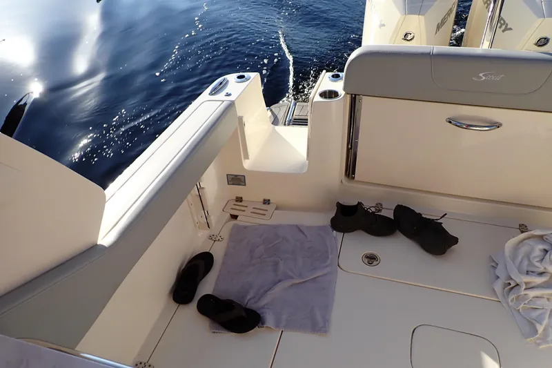  Yacht Photos Pics 2021 Scout 277 Dorado boat interior with shoes and towel on deck.