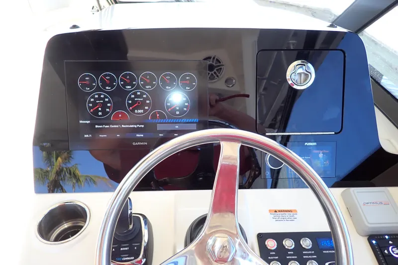  Yacht Photos Pics 2021 Scout 277 Dorado dashboard with Garmin display and steering wheel.
