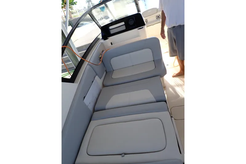  Yacht Photos Pics 2021 Scout 277 Dorado boat interior with cushioned seating and dashboard view.