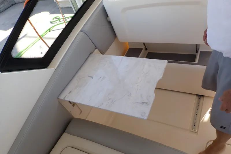  Yacht Photos Pics 2021 Scout 277 Dorado interior with marble table and seating area.