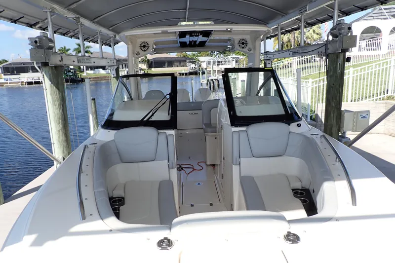  Yacht Photos Pics 2021 Scout 277 Dorado boat interior with seating and canopy in a marina setting.