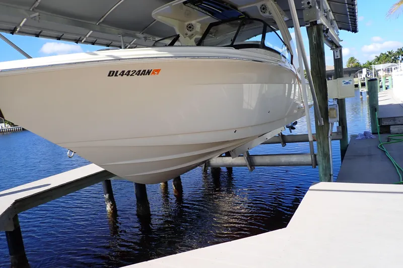  Yacht Photos Pics 2021 Scout 277 Dorado boat on lift, docked by waterfront.