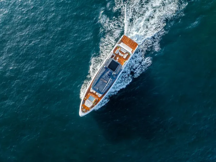  Yacht Photos Pics Aerial view of 2025 Majesty 100 Terrace yacht cruising on open sea.