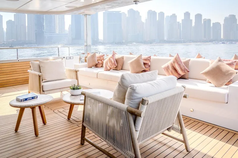  Yacht Photos Pics Luxurious 2025 Majesty 100 Terrace yacht deck with elegant seating and city skyline view.