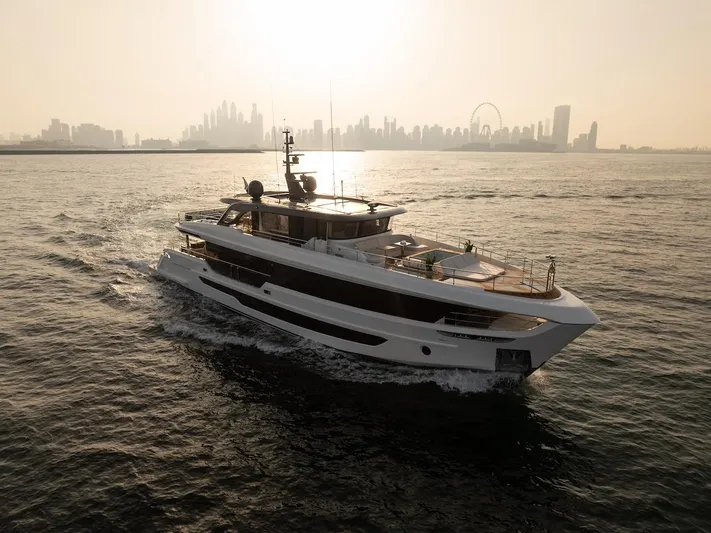  Yacht Photos Pics Majesty 100 Terrace yacht cruising with city skyline backdrop, 2025 model.