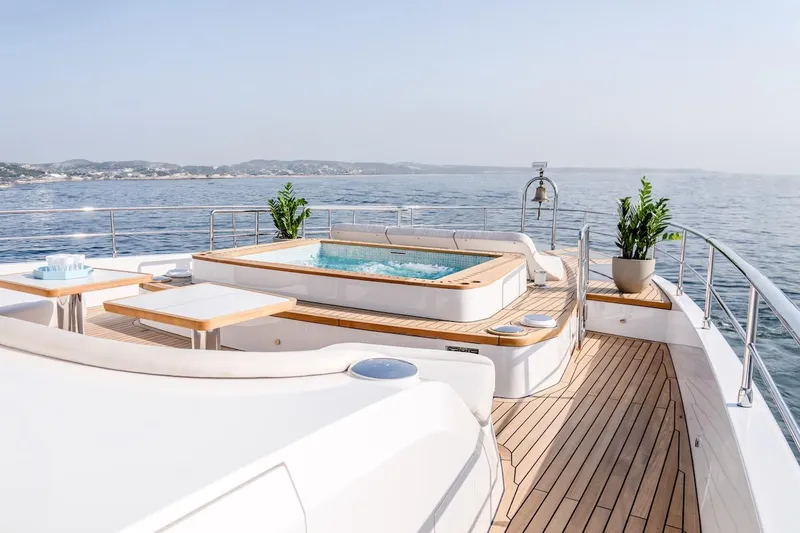  Yacht Photos Pics Luxurious 2025 Majesty 100 Terrace yacht deck with jacuzzi and ocean view.
