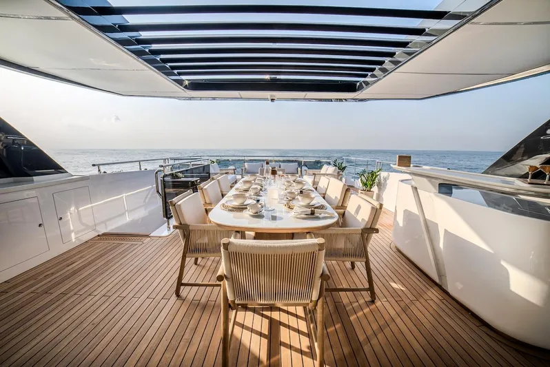  Yacht Photos Pics Luxurious dining area on 2025 Majesty 100 Terrace yacht with ocean view.