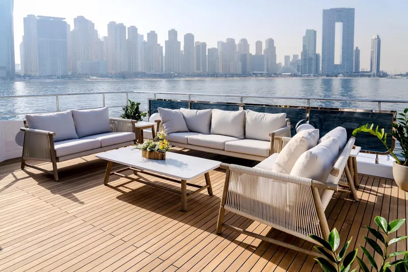  Yacht Photos Pics Luxurious 2025 Majesty 100 Terrace yacht deck with elegant seating, overlooking city skyline.