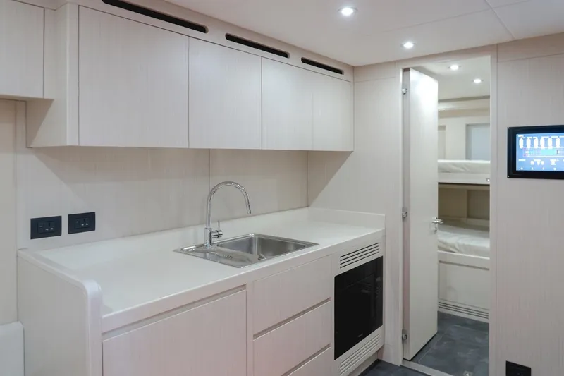  Yacht Photos Pics Modern kitchen interior in 2025 Majesty 100 Terrace yacht, featuring sleek cabinetry and integrated appliances.