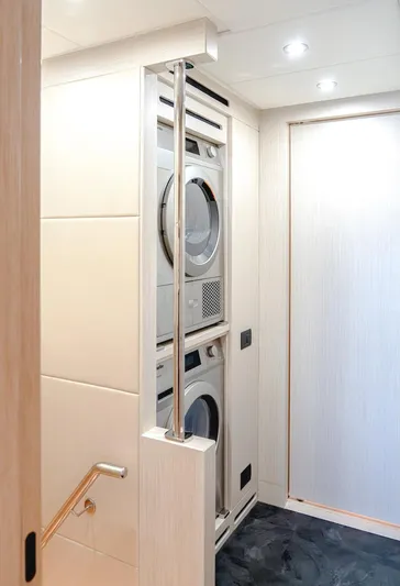  Yacht Photos Pics Modern laundry area in 2025 Majesty 100 Terrace yacht, featuring stacked washer and dryer.