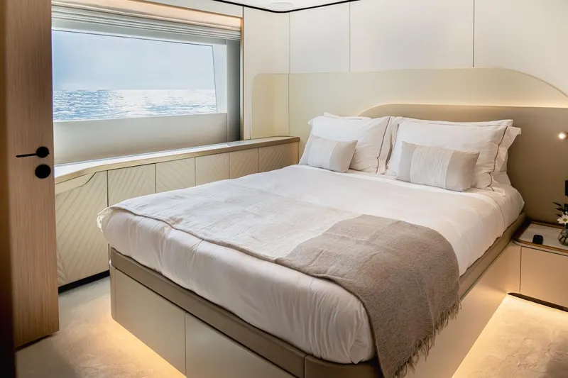 Yacht Photos Pics Luxurious bedroom interior on Majesty 100 Terrace yacht, 2025 model, with ocean view window.