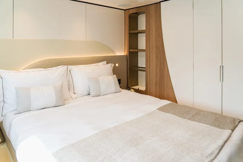  Yacht Photos Pics Luxurious bedroom interior in 2025 Majesty 100 Terrace yacht, featuring modern design and cozy bedding.