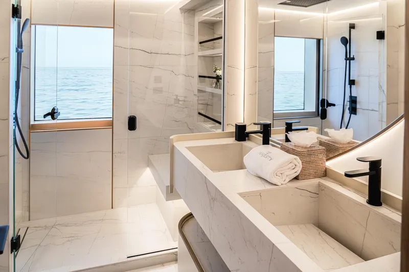  Yacht Photos Pics Luxurious bathroom in 2025 Majesty 100 Terrace yacht with ocean view and modern fixtures.