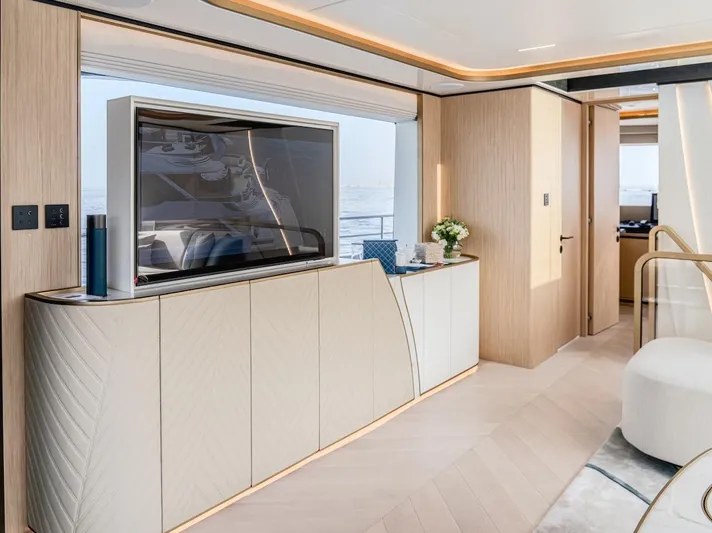  Yacht Photos Pics Luxurious interior of 2025 Majesty 100 Terrace yacht with modern decor and large TV.