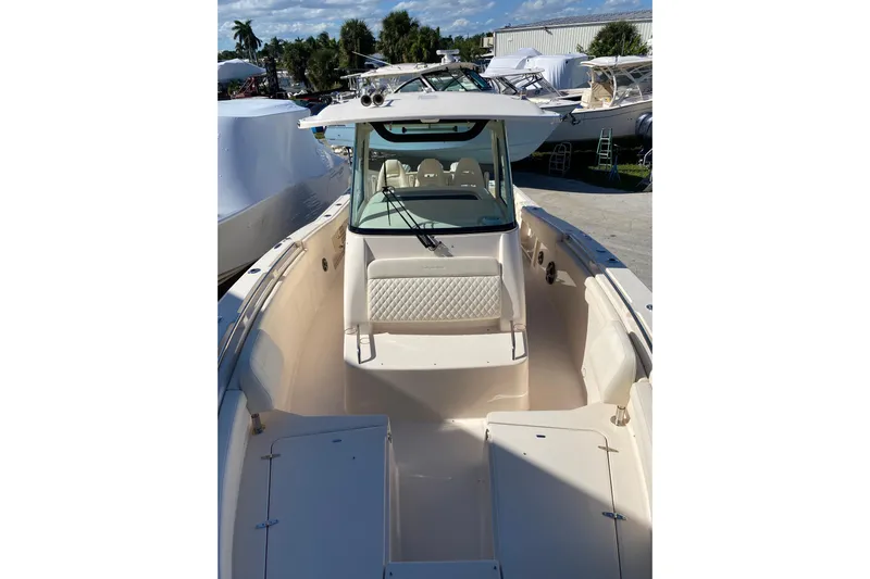  Yacht Photos Pics 2026 Grady-White Canyon 336 boat, spacious deck, luxurious seating, marina background.