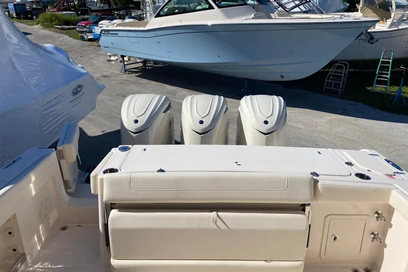  Yacht Photos Pics 2026 Grady-White Canyon 336 boat with triple outboard engines, docked outdoors.