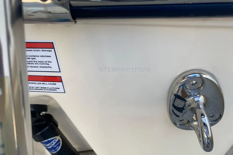  Yacht Photos Pics 2026 Grady-White Canyon 336 boat detail with warning label and metal fixture.