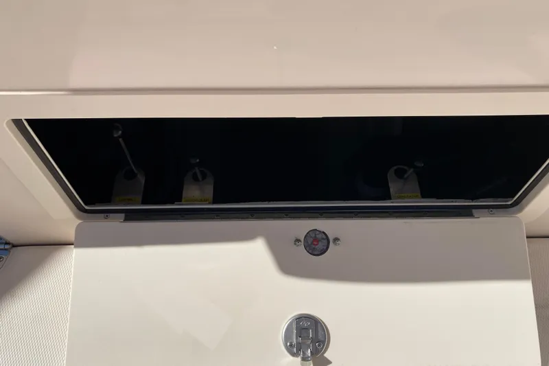  Yacht Photos Pics 2026 Grady-White Canyon 336 storage compartment with latch and shadow detail.