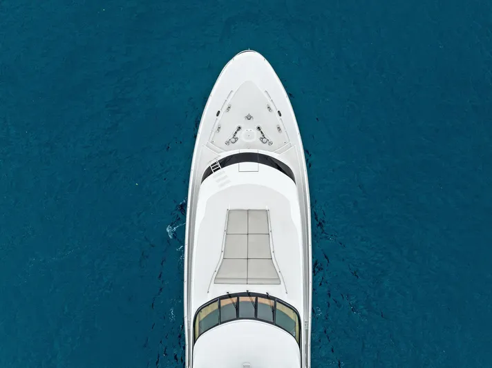 Invictus Yacht Photos Pics Aerial view of 2006 Palmer Johnson motor yacht on blue ocean water.