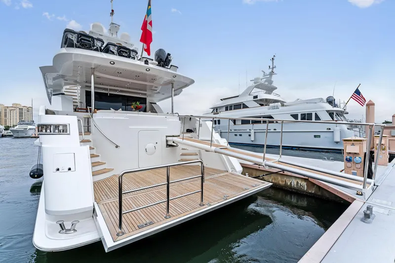 Invictus Yacht Photos Pics Palmer Johnson 2006 motor yacht docked at marina with boarding ramp.