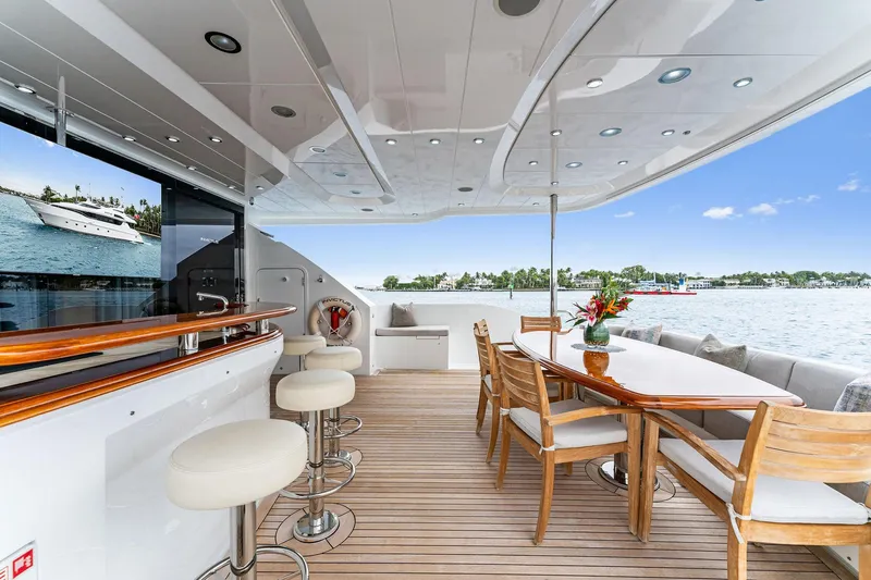 Invictus Yacht Photos Pics Luxurious 2006 Palmer Johnson motor yacht deck with bar and dining area.