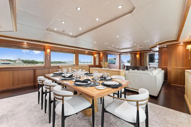 Invictus Yacht Photos Pics Luxurious dining area on a 2006 Palmer Johnson motor yacht, featuring elegant table settings and plush seating.