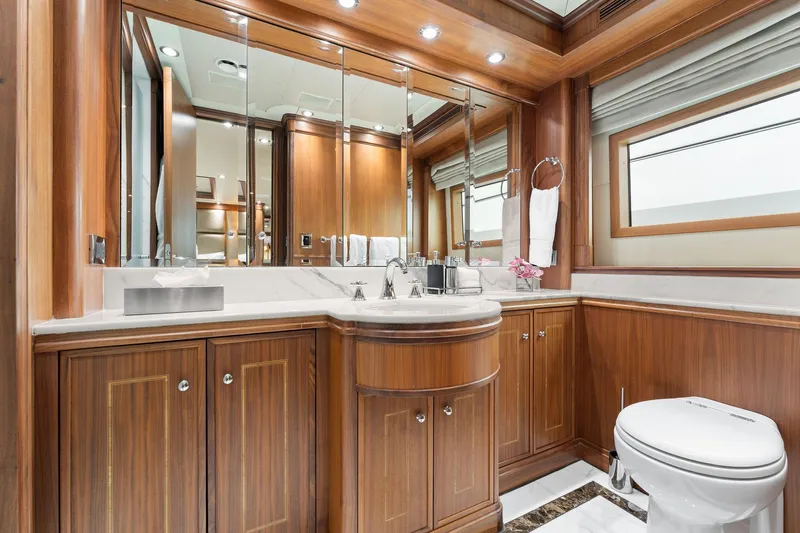 Invictus Yacht Photos Pics Luxurious 2006 Palmer Johnson motor yacht bathroom with wood cabinetry and elegant fixtures.
