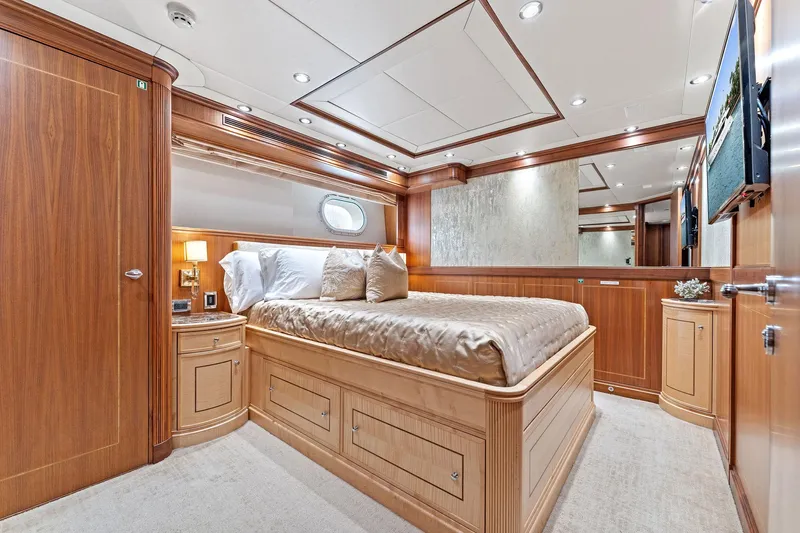 Invictus Yacht Photos Pics Luxurious 2006 Palmer Johnson motor yacht bedroom with elegant wood paneling and cozy bedding.