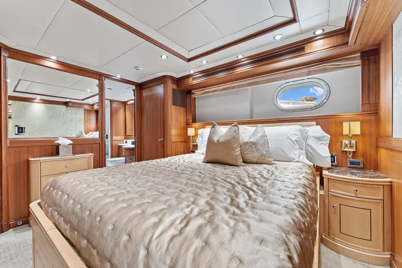 Invictus Yacht Photos Pics Luxurious bedroom interior of a 2006 Palmer Johnson motor yacht with elegant wood finishes.