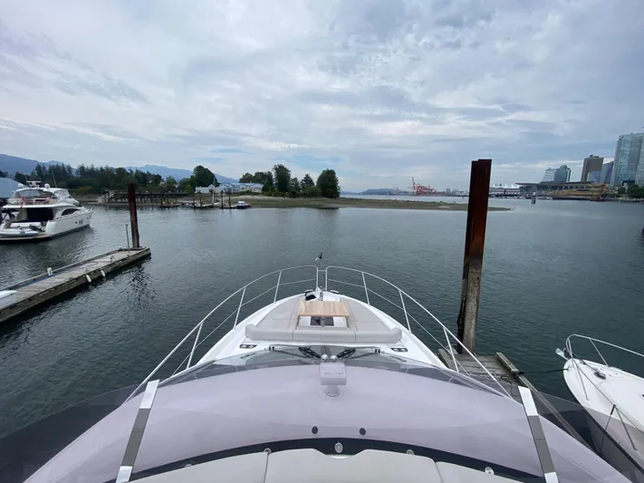 Sea Sea V Yacht Photos Pics Sunseeker Manhattan 52 yacht docked in a serene marina, 2020 model.