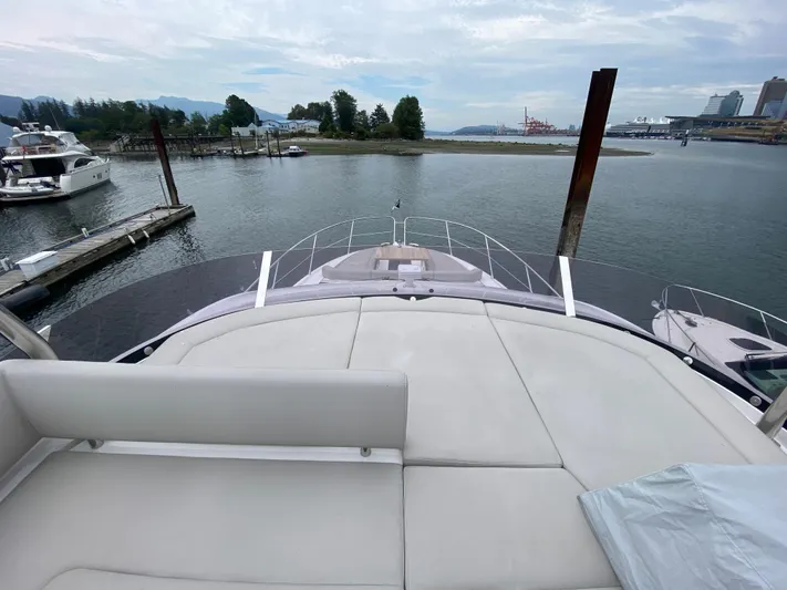Sea Sea V Yacht Photos Pics Sunseeker Manhattan 52 yacht, 2020 model, docked in a serene marina setting.