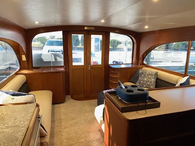 Full Circle Yacht Photos Pics Interior of 1984 Custom Carolina Buddy Davis yacht with wooden finishes and large windows.