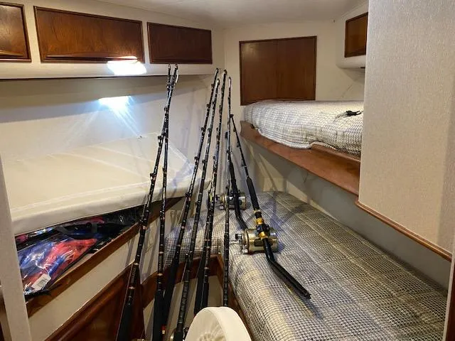 Full Circle Yacht Photos Pics Interior of 1984 Custom Carolina Buddy Davis boat with fishing rods and bunk beds.