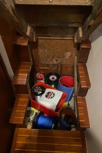 Full Circle Yacht Photos Pics 1984 Custom Carolina Buddy Davis boat storage area with fishing gear and supplies.