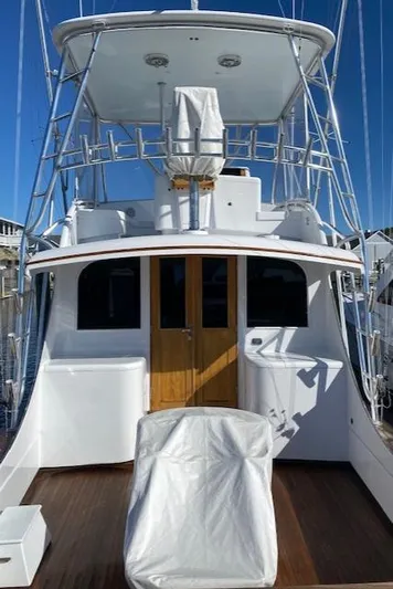 Full Circle Yacht Photos Pics 1984 Custom Carolina Buddy Davis boat with covered seating and wooden doors.