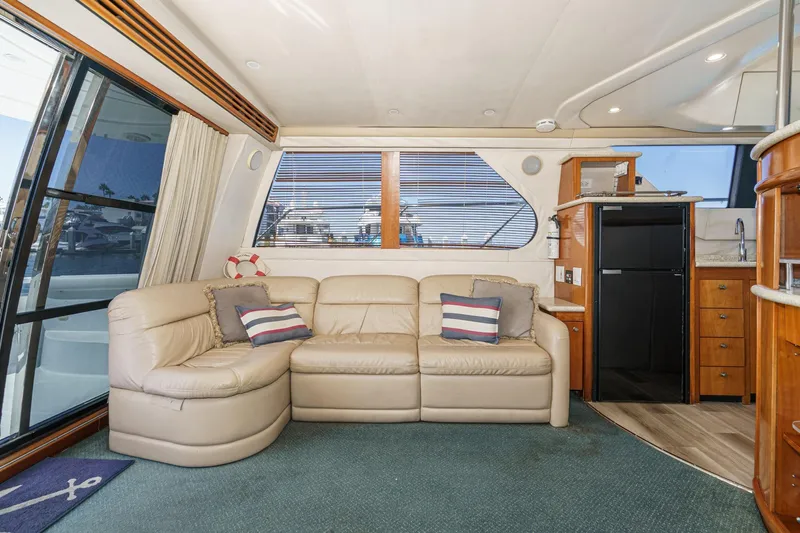 Kathy's Dream Yacht Photos Pics Interior of 2000 Carver 450 Voyager Pilothouse with leather sofa and kitchenette.