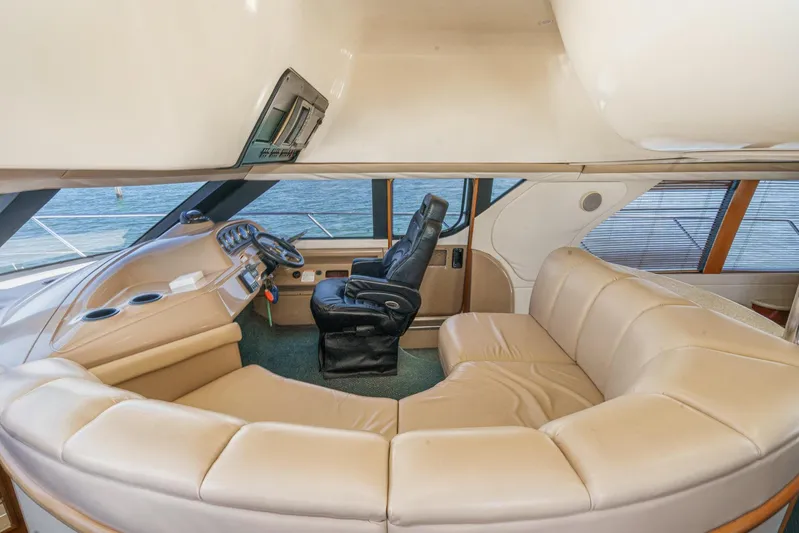 Kathy's Dream Yacht Photos Pics Luxurious interior of 2000 Carver 450 Voyager Pilothouse with leather seating and helm.