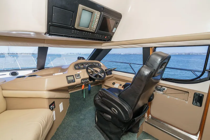 Kathy's Dream Yacht Photos Pics Interior of 2000 Carver 450 Voyager Pilothouse with steering wheel and navigation equipment.