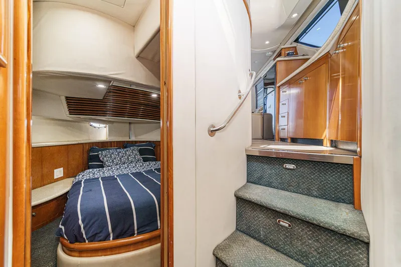 Kathy's Dream Yacht Photos Pics Interior of 2000 Carver 450 Voyager Pilothouse with cozy bedroom and elegant staircase.