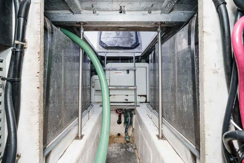 Kathy's Dream Yacht Photos Pics Engine room of 2000 Carver 450 Voyager Pilothouse with Kohler generator and hoses.