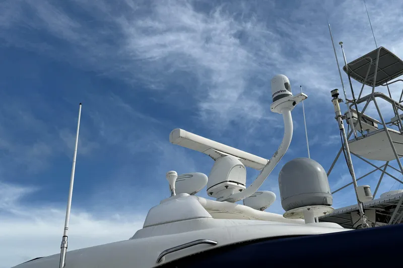 Turn The Page Yacht Photos Pics Radar and communication equipment on a 2006 Sea Ray 48 Sundancer against a blue sky.