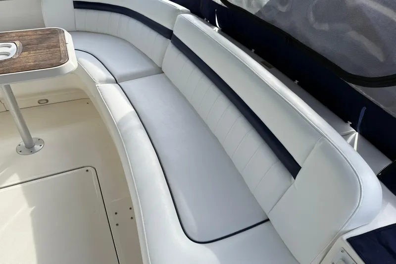 Turn The Page Yacht Photos Pics Luxurious seating area on a 2006 Sea Ray 48 Sundancer yacht with wooden table.