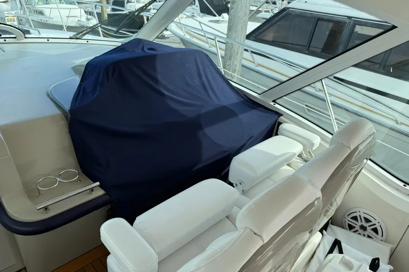 Turn The Page Yacht Photos Pics 2006 Sea Ray 48 Sundancer cockpit with covered helm and white seating.