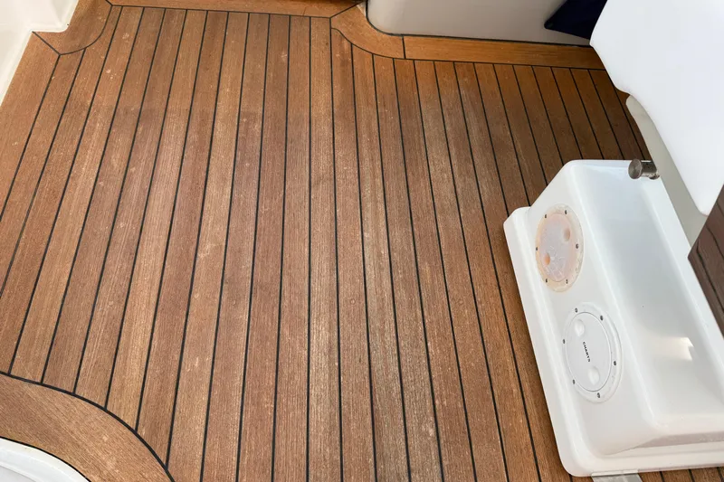 Turn The Page Yacht Photos Pics Teak deck of 2006 Sea Ray 48 Sundancer yacht, featuring clean lines and white fixtures.